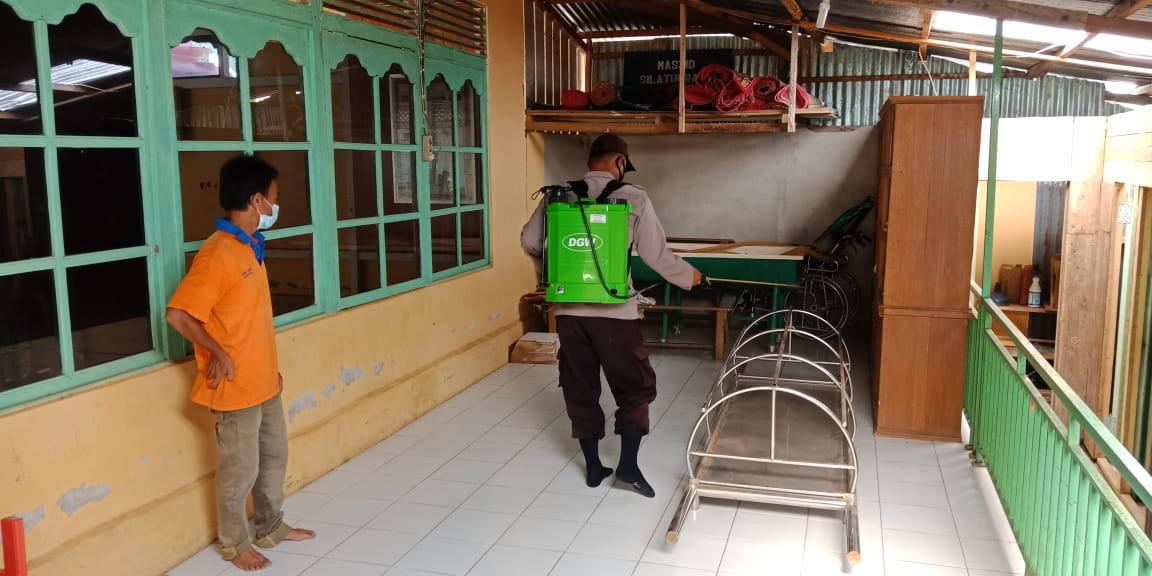 SEMPROT: Personel Polsek Meranti menyemprotkan cairan disinfektan di Masjid Silaturahim Meranti, Minggu (18/4). ISTIMEWA