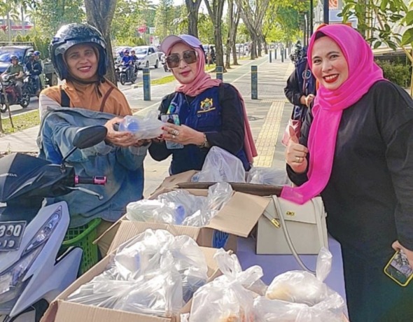 Hj Wina Handayani SE MM, Ketua Yayasan Peduli Masyarakat Khatulistiwa saat membagikan ratusan takjil gratis kepada masyarakat di Kota Pontianak. foto YPMK