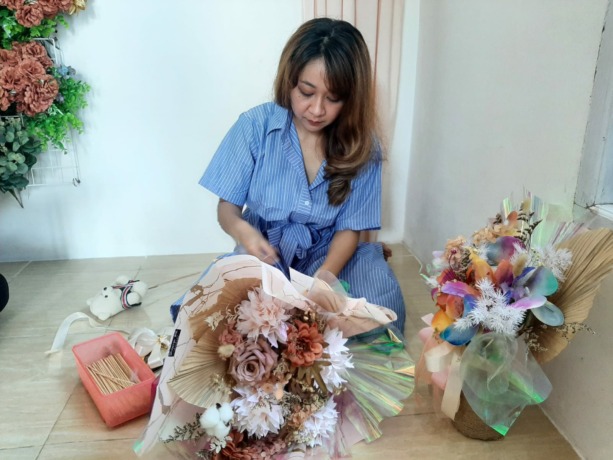 Kristin Sisilia, owner dari Surpise Me Florist sedang merangkai bouquet bunga. Usaha ini telah dirintisnya sejak tahun 2016. (Syahriani Siregar/Pontianak Post)
