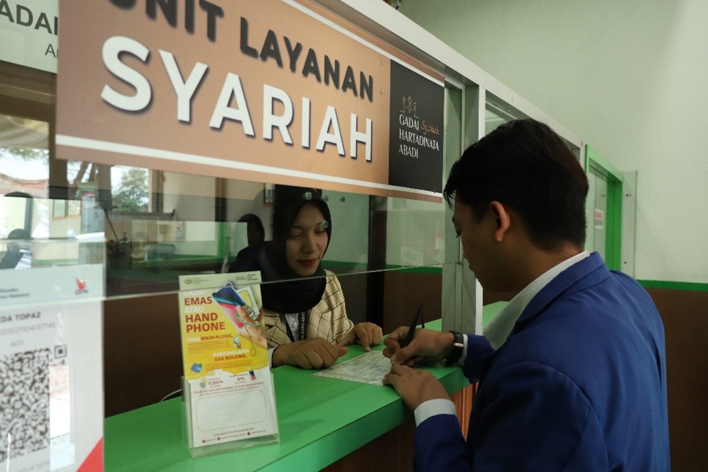 Seorang nasabah Layanan Syariah Hartadinata Abadi melakukan transaksi gadai.