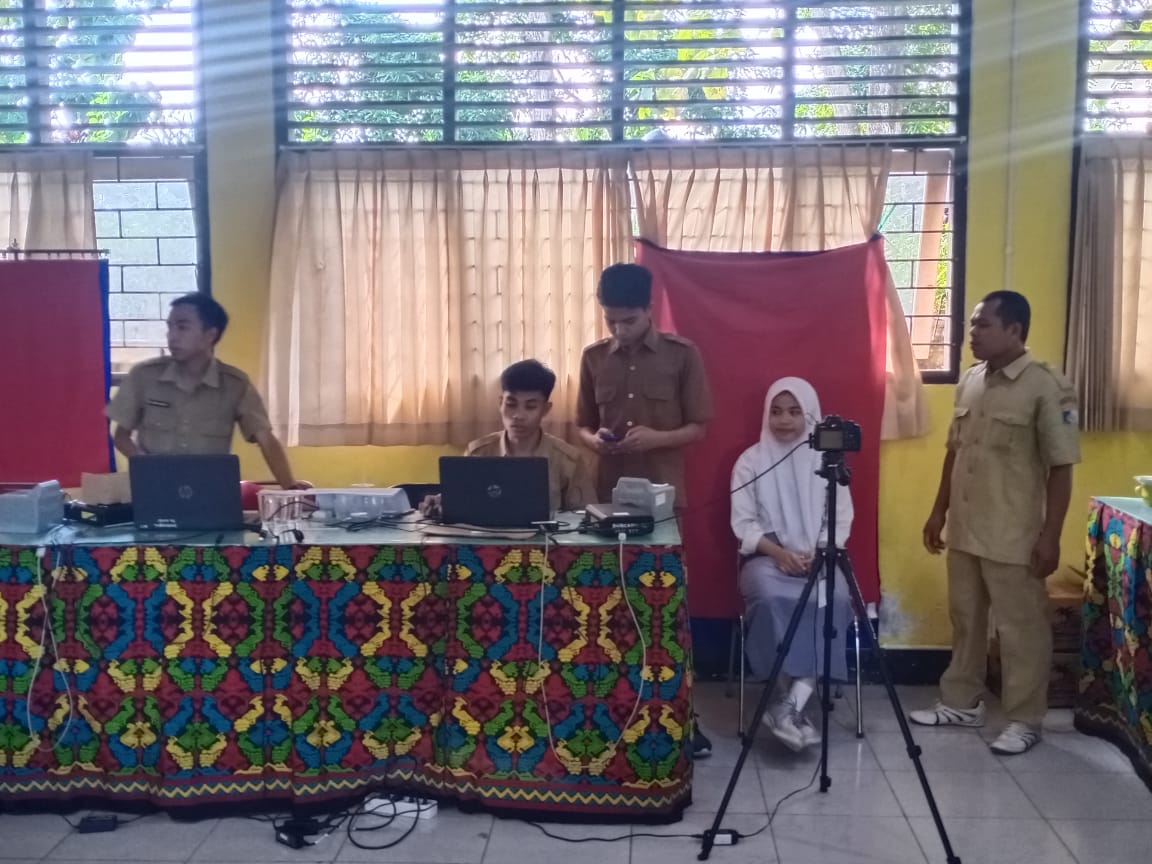 KEJAR PEMILIH PEMULA: Petugas Dinas Dukcapil melakukan perekaman kepada salah satu siswa wajib KTP, di salah satu sekolah. (HABIBUL ADNAN/LOMBOK POST)