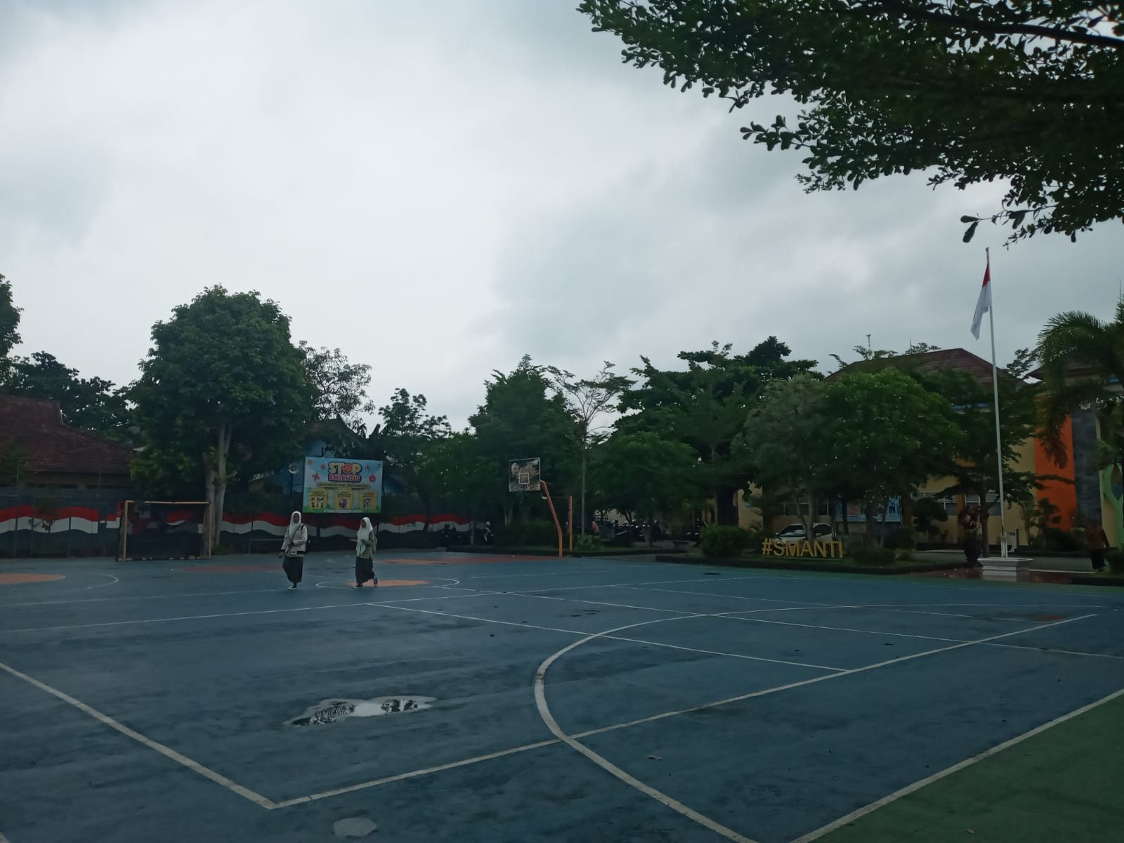 PULANG SEKOLAH: Dua orang siswa SMAN 3 Mataram jalan kaki di lapangan sekolah saat jam pulang. (ROJAI/LOMBOK POST)