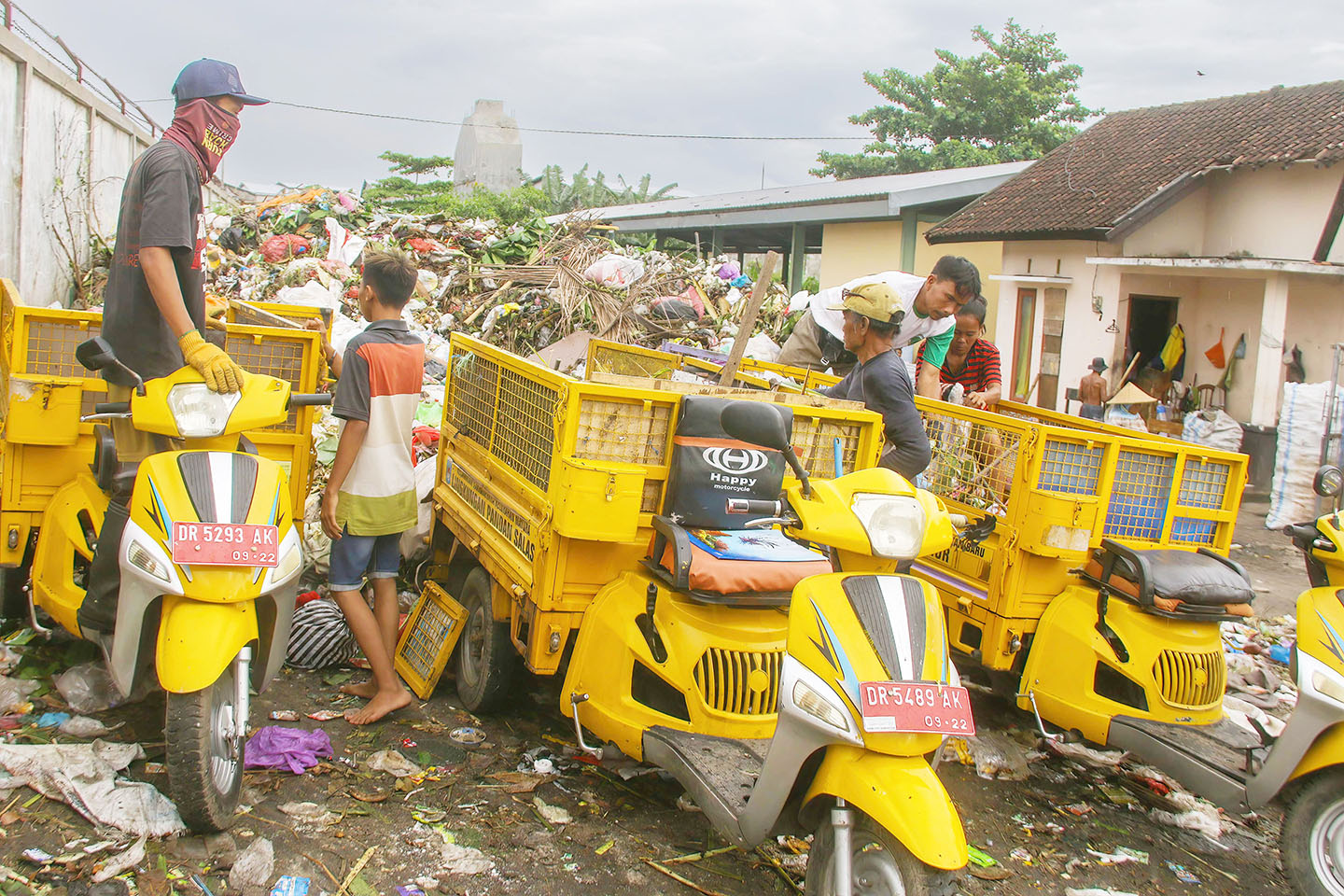 Pertugas pengangkut sampah di kelurahan membuang sampah dari motor angkutnya ke TPS Sandubaya, beberapa waktu lalu.