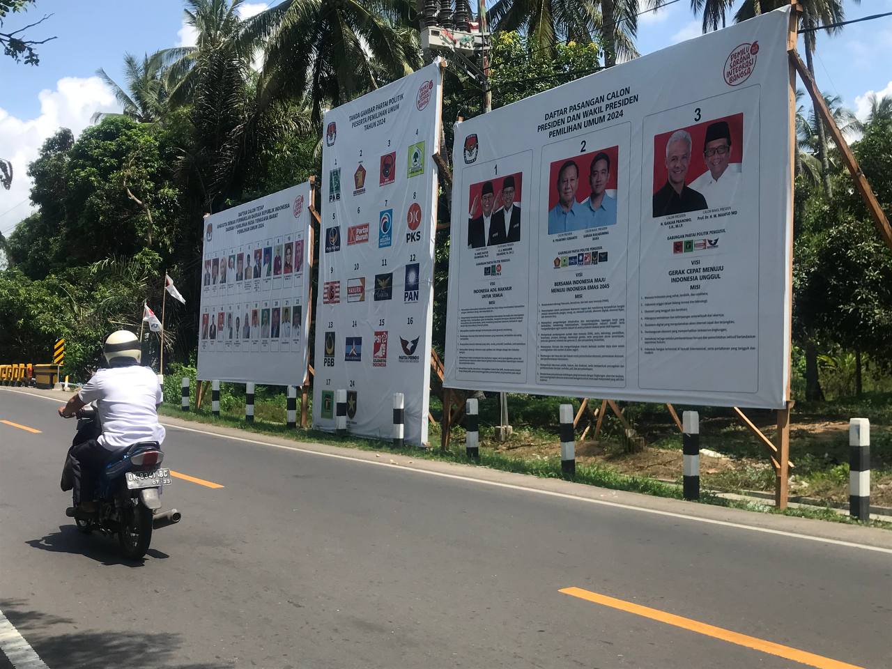 INFO PILPRES: Seorang pengemudi kendaraan melalui papan informasi visi misi calon Pilpres di Pemenang, Rabu (17/1).