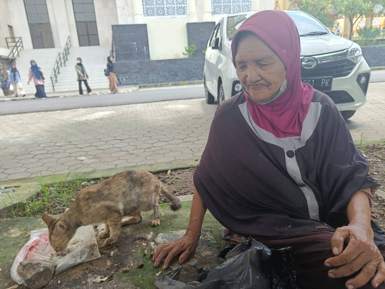Rabiah dan seekor kucing di kompleks Islamic Center, Kota Mataram