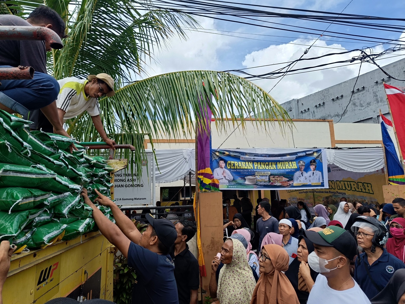 ZAD/LOMBOK POST  DISERBU: Warga tengah membeli beras pada vendor Bulog di acara GPM Dinas Ketahanan Pangan Kota Mataram,&nbsp;Senin (1/4). (FOTO: ZAD/LOMBOK POST)