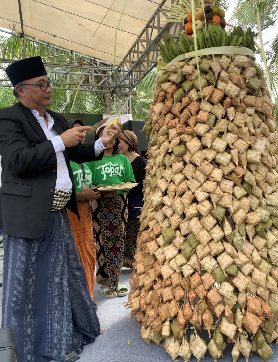 PERAYAAN: Kepala Dispar Lombok Barat sedang memotong ketupat dalam perayaan tradisi lebaran topat di Tanjung Bias, Batu Layar, kemarin (17/4).