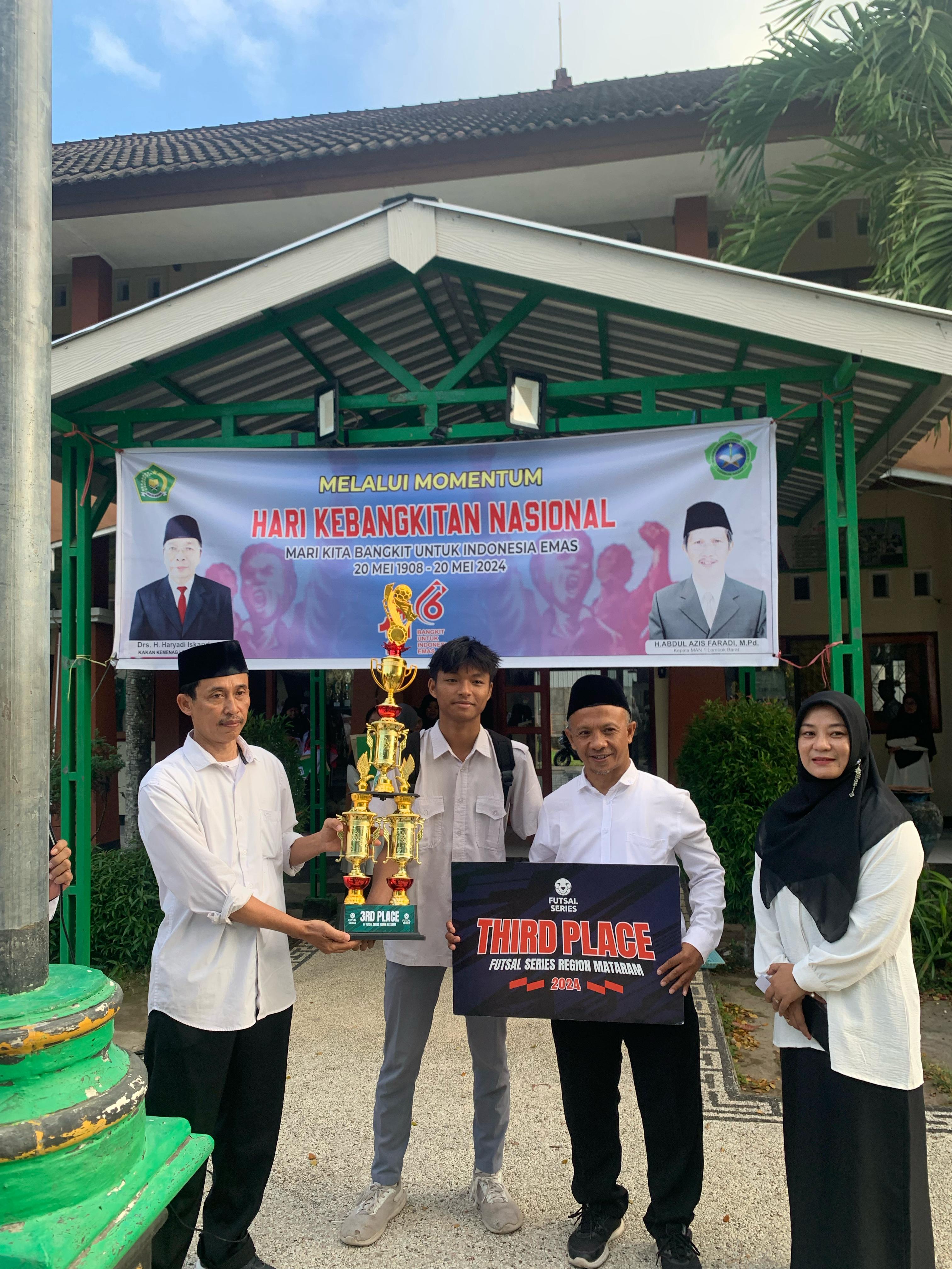 BERPERTASI: Plh Kepala MAN Lobar Agus Setiyono menunjukkan piala yang diraih tim futsal madrasah setempat, kemarin. (MAN LOBAR FOR LOMBOK POST)