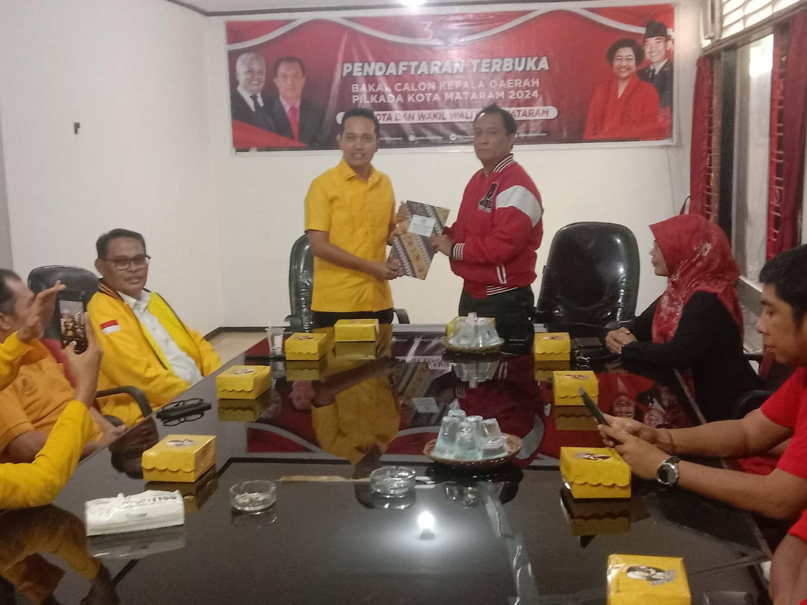 MANUVER: Firadz Pariska menyerahkan berkas pendaftaran H Mohan Roliskana ke DPC PDIP Kota Mataram diterima Made Slamet, kemarin (28/5). (ZAD/LOMBOK POST)