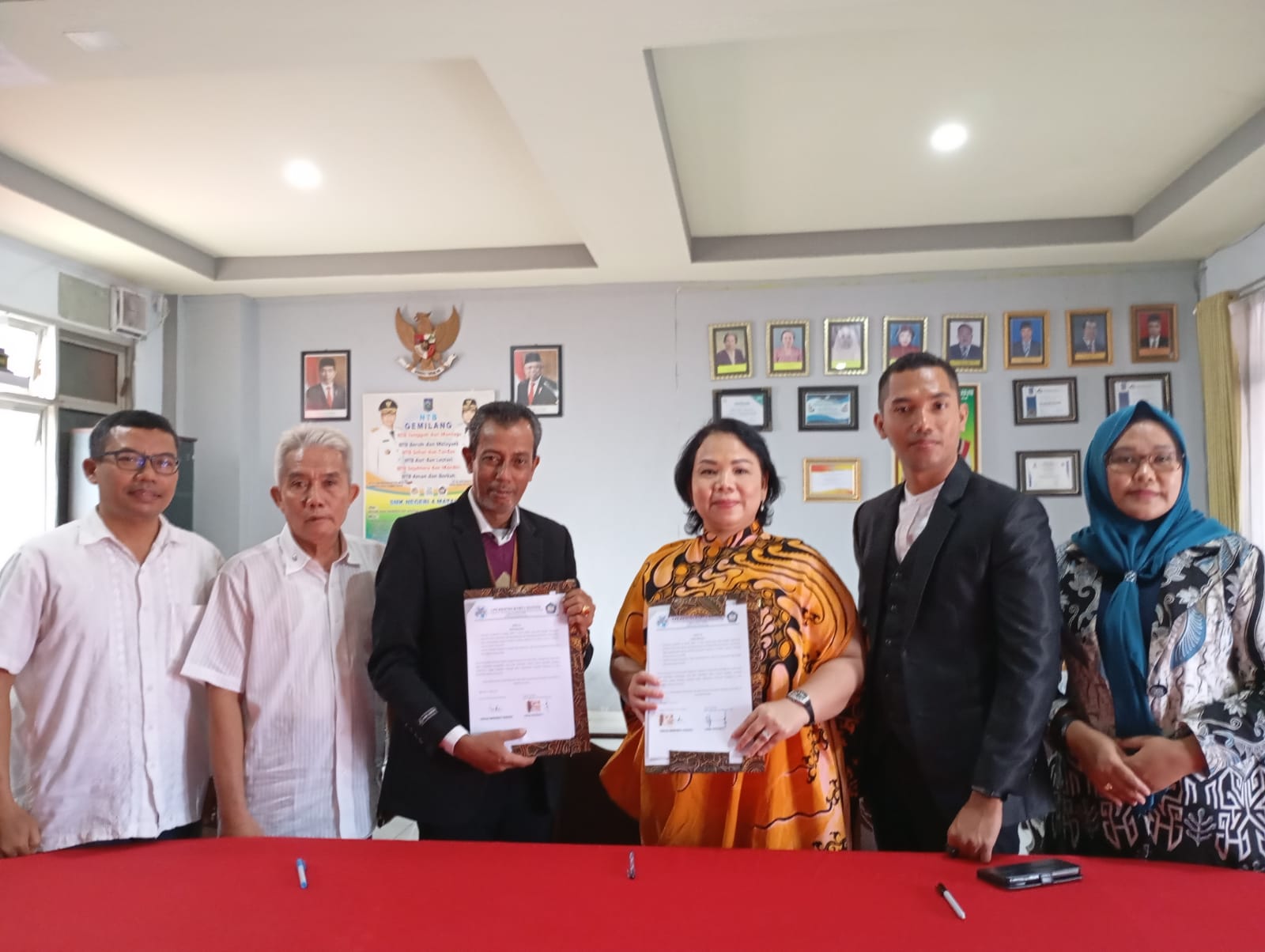 KERJA SAMA: Kepala SMKN 4 Mataram Iwan Supriadi (tiga dari kiri) dan Direktur LPK KKB Imelda Indrawaty menunjukkan MoU yang ditandatangani di sekolah setempat, kemarin (31/7).(ROJAI/LOMBOK POST)