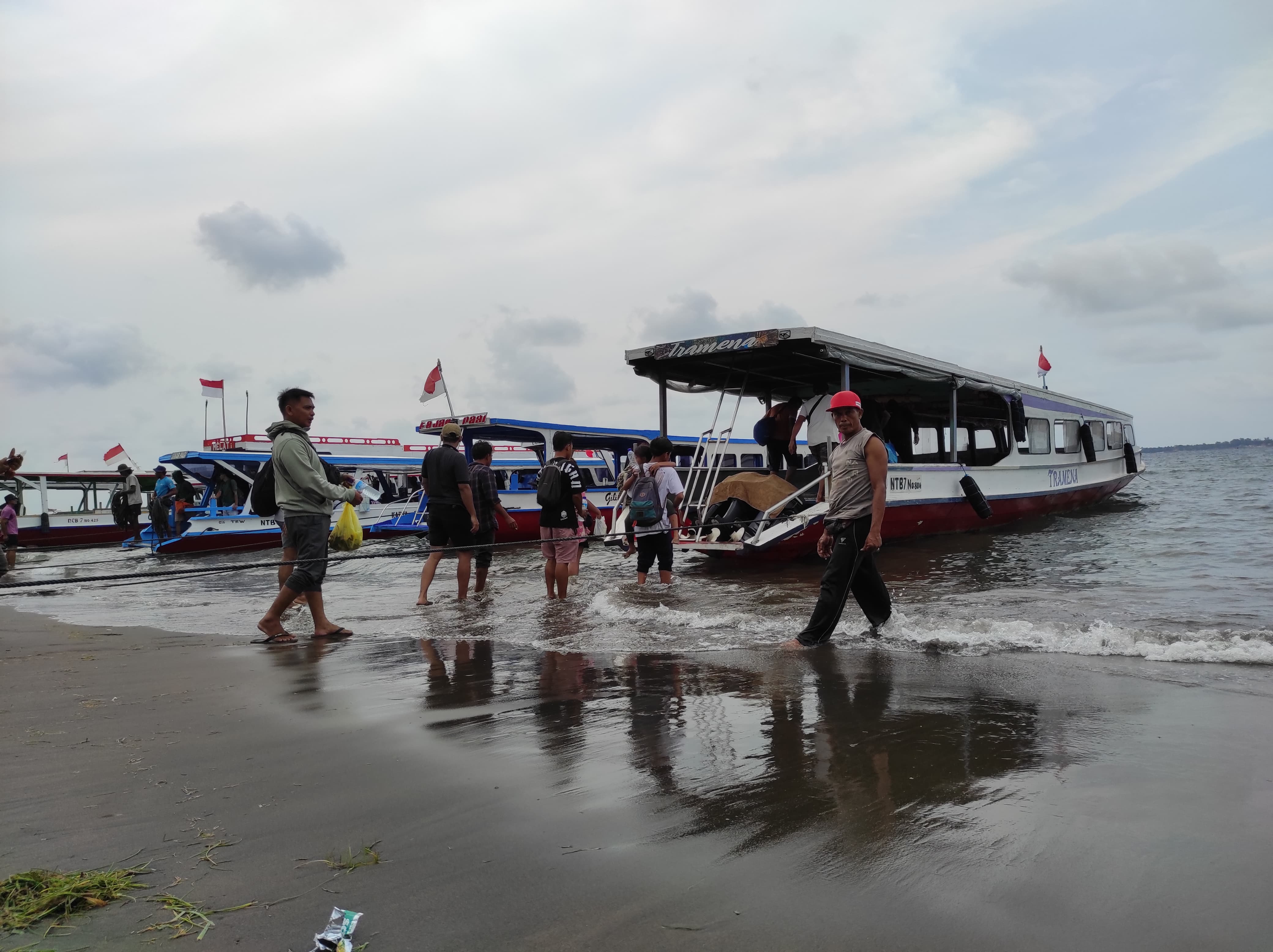 SEBERANGKAN PENUMPANG: Sejumlah penumpang menaiki kapal penyeberangan dari Bangsal menuju Gili Tramena, pekan lalu.(IST/LOMBOK POST)