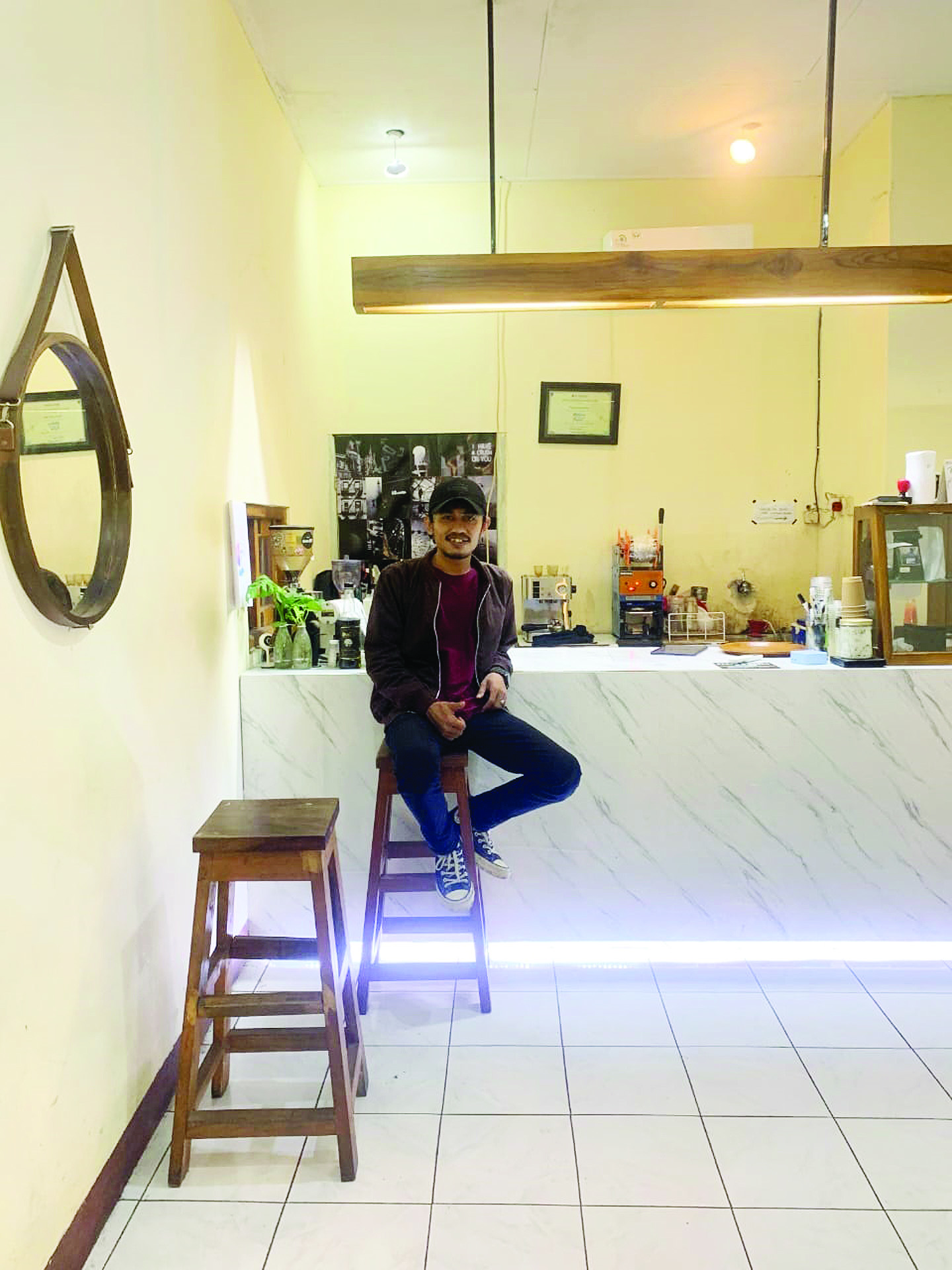 TUNGGU PELANGGAN: Seorang pegawai duduk di Kedai Kopi, Teman Lama Kopi di Jalan Musi 2 Nomor 1,Kekalik Mataram, beberapa waktu lalu.