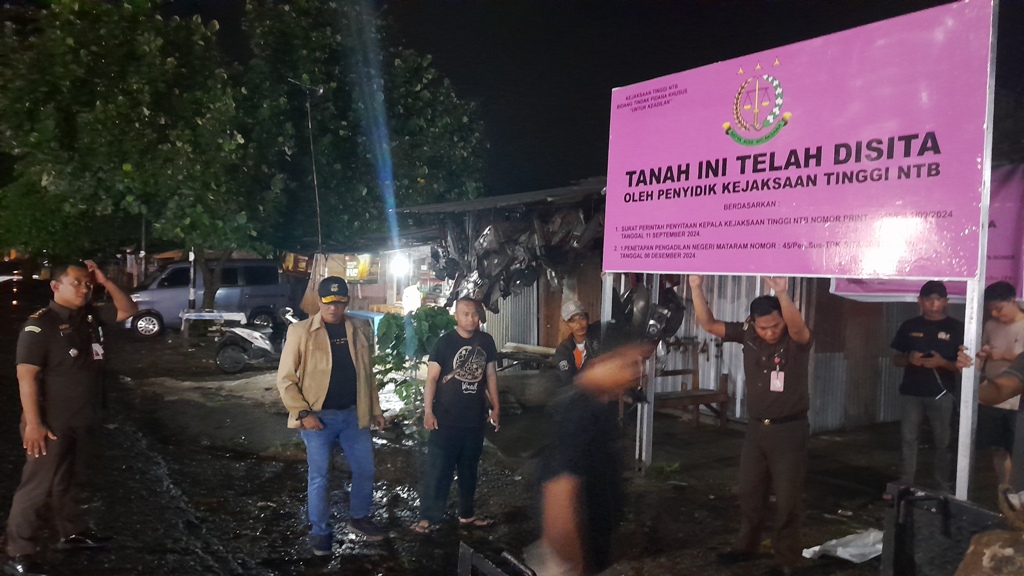 DISITA: Tim penyidik Kejati NTB memasang plang penyitaan aset lahan Pemda Lobar sebagai barang bukti, Senin malam (9/12).&nbsp;
