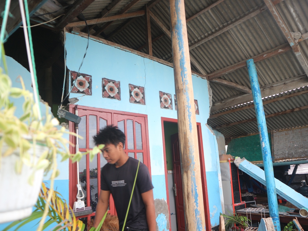 BENCANA: Lalu Iqbal Ranggajati, warga Gili Re, Desa Pare Mas, Kecamatan Jerowaru, saat membersihkan reruntuhan rumahnya akibat diterjang hujan dan angin kencang, Selasa (10/12).