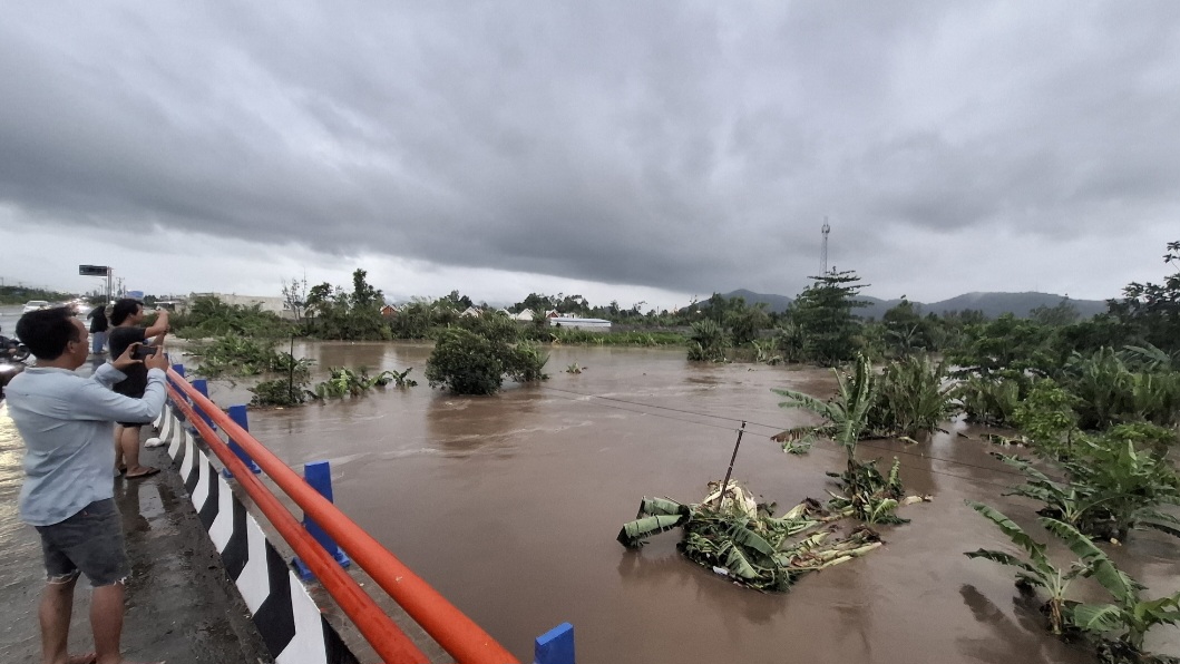 MELUAP: Debit air Sungai Babak yang melintasi wilayah Labuapi terpantau masih tinggi. Kondisi ini membahayakan warga sekitar daerah aliran sungai.
