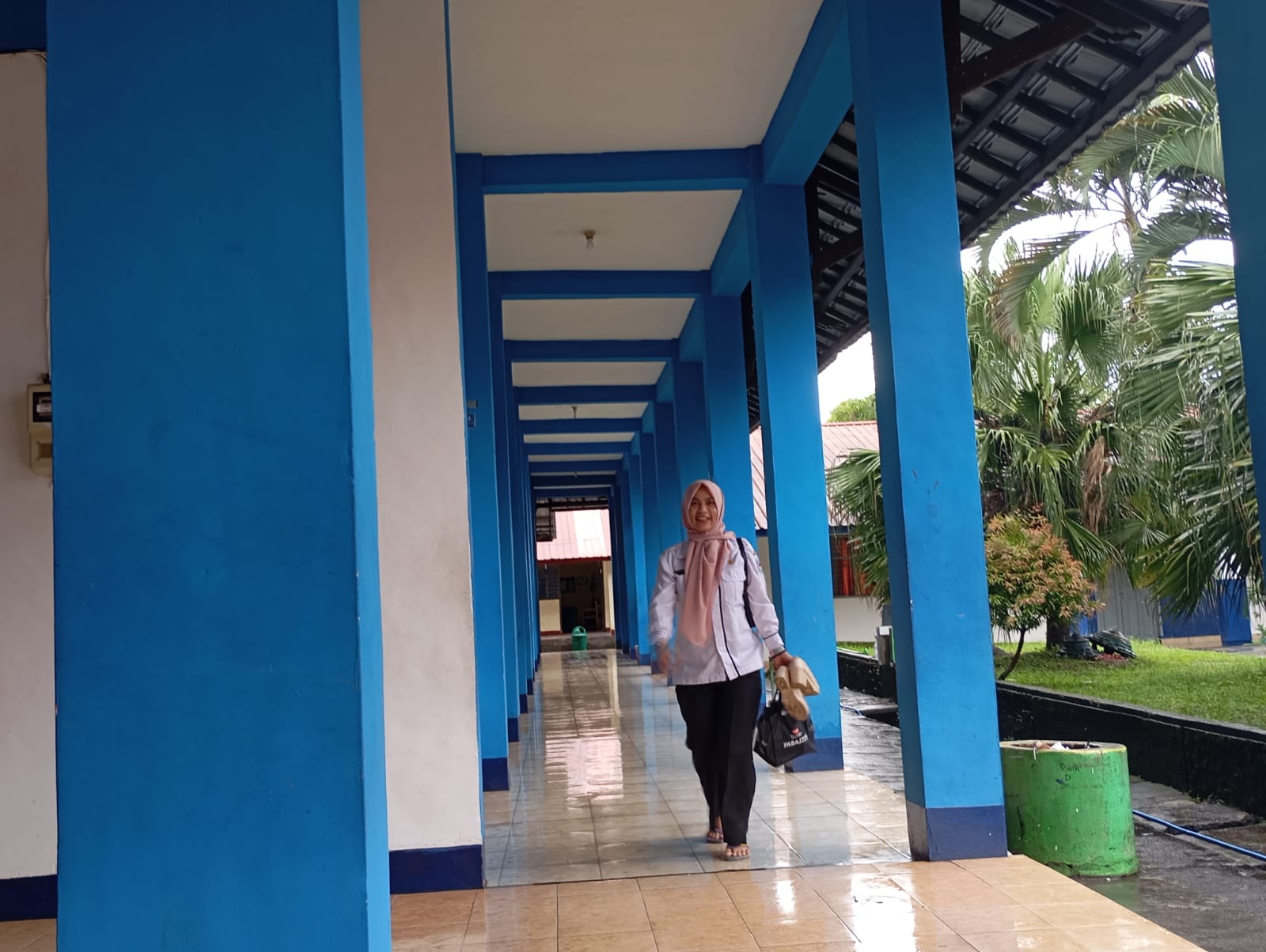 AKAN DITERAPKAN: Guru SMPN 7 Mataram berjalan di teras sekolah saat jam pulang di sekolah setempat, Rabu (12/2).