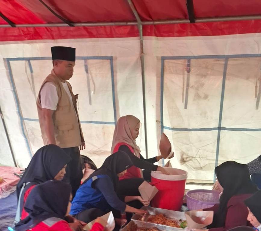 UNTUK KORBAN BENCANA: Petugas Tagana Dinsos Lobar sibuk memasak untuk korban bencana banjir di dapur umum kantor Camat Labuapi, Jumat (14/2).