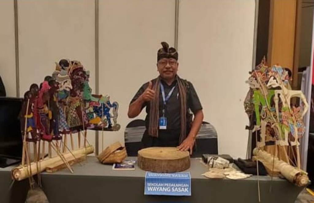 MELESTARIKAN BUDAYA SASAK: Safwan menunjukkan tokoh-tokoh wayang Sasak hasil kreasinya dalam suatu festival.
