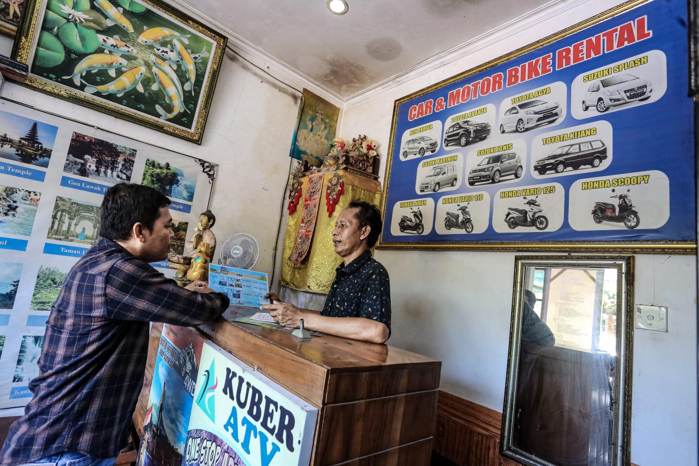 Pemilik rental mobil Bangkoks Bali Wisata Made Merta (kanan) sedang berbincang dengan konsumen mengenai keunggulan Daihatsu Terios di Ubud, Bali, akhir pekan lalu.&nbsp;