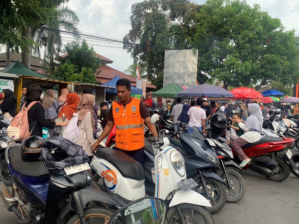 KEJAR TARGET: Seorang petugas juru parkir di depan Taman Budaya beberapa waktu lalu.&nbsp;Pemkot Mataram mengimbau masyarakat untuk membayar parkir menggunakan Qris.