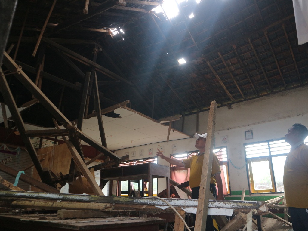 RUSAK: Kepala SDN 6 Batuyang dan SMPN Satap 2 Pringgabaya Muksin melihat kondisi ruangan belajar yang roboh karena termakan usia, Jumat (11/4).