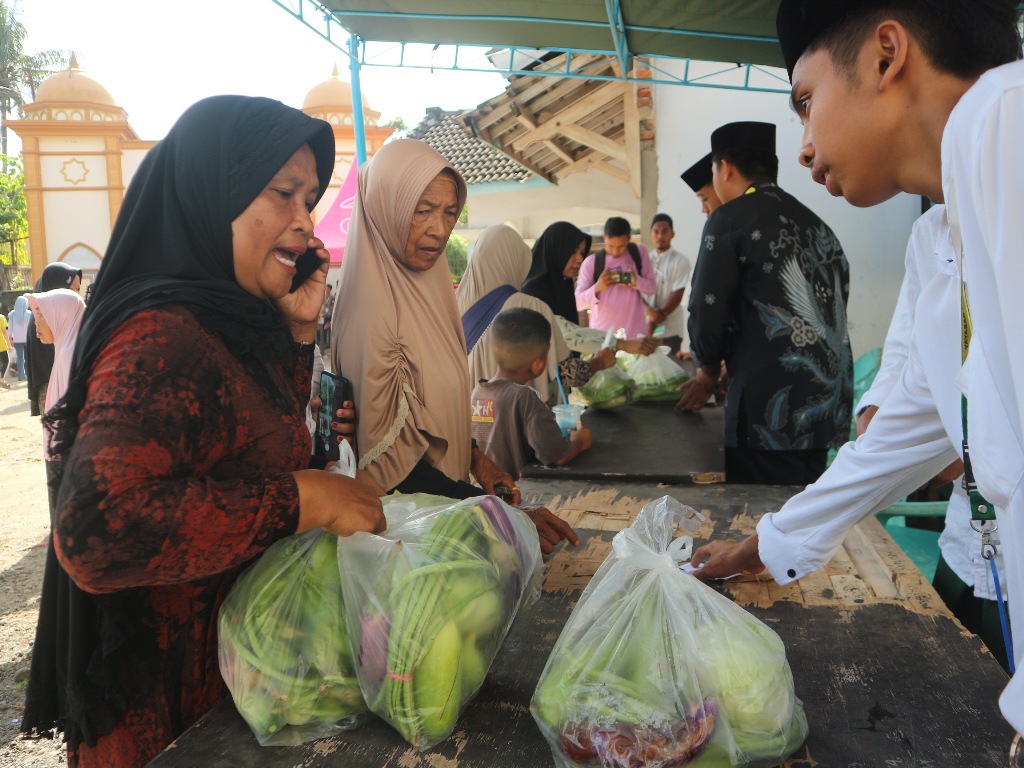 BERBAGI: Santri Al Badriah saat membagikan paket sayur-sayuran kepada masyarakat Desa Rarang saat acara reuni akbar dan halalbihalal, Senin (28/4).