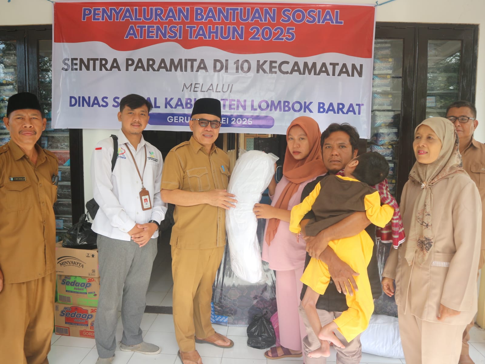 SALURKAN BANTUAN: Kepala Dinas Sosial Lombok Barat Lalu Winengan bersama Peksos Sentra Paramita Mataram saat menyalurkan bantuan layak hidup secara simbolis kepada warga, Senin (26/5).