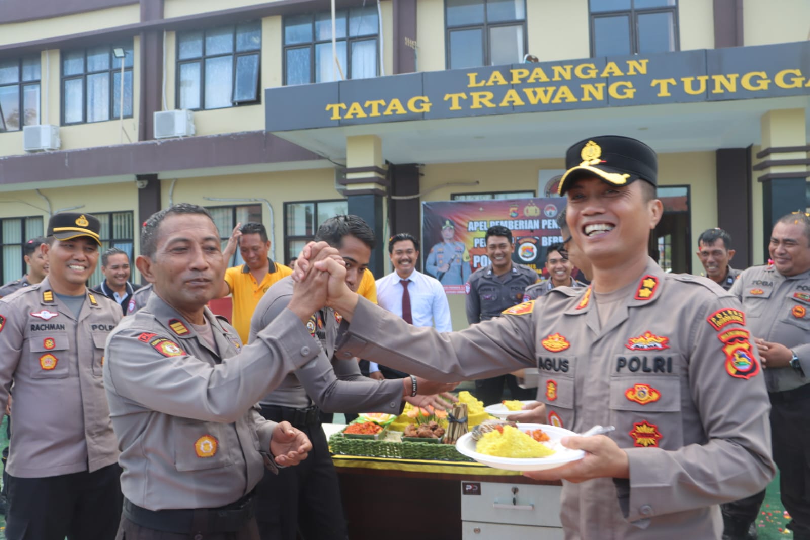 Kapolres Lombok Utara AKBP Agus Purwanta (kanan) memberikan nasi tumpeng kepada personel yang berprestasi.