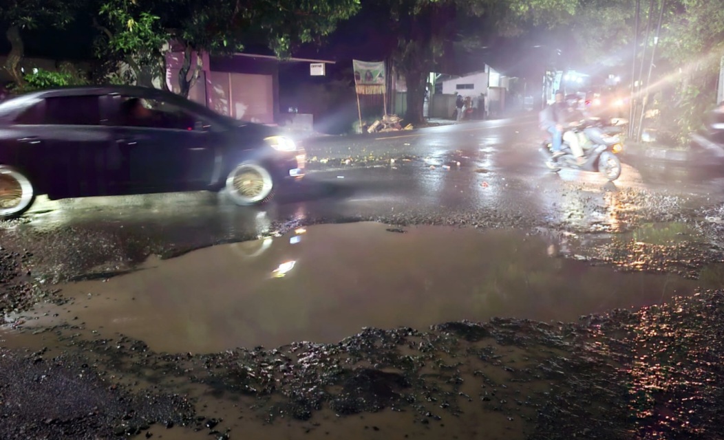 JALAN PROVINSI: Ruas jalan provinsi yang rusak di Jalan Pejanggik, Kota Praya, Lombok Tengah membentuk genangan air usai hujan lebat beberapa waktu lalu.