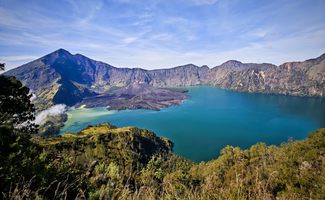 MAGNET WISATAWAN: Pemandangan puncak Gunung Rinjani dengan latar belakang Danau Segara Anak. Jalur pendakian menuju puncak Rinjani akan ditutup hingga 10 Agustus.