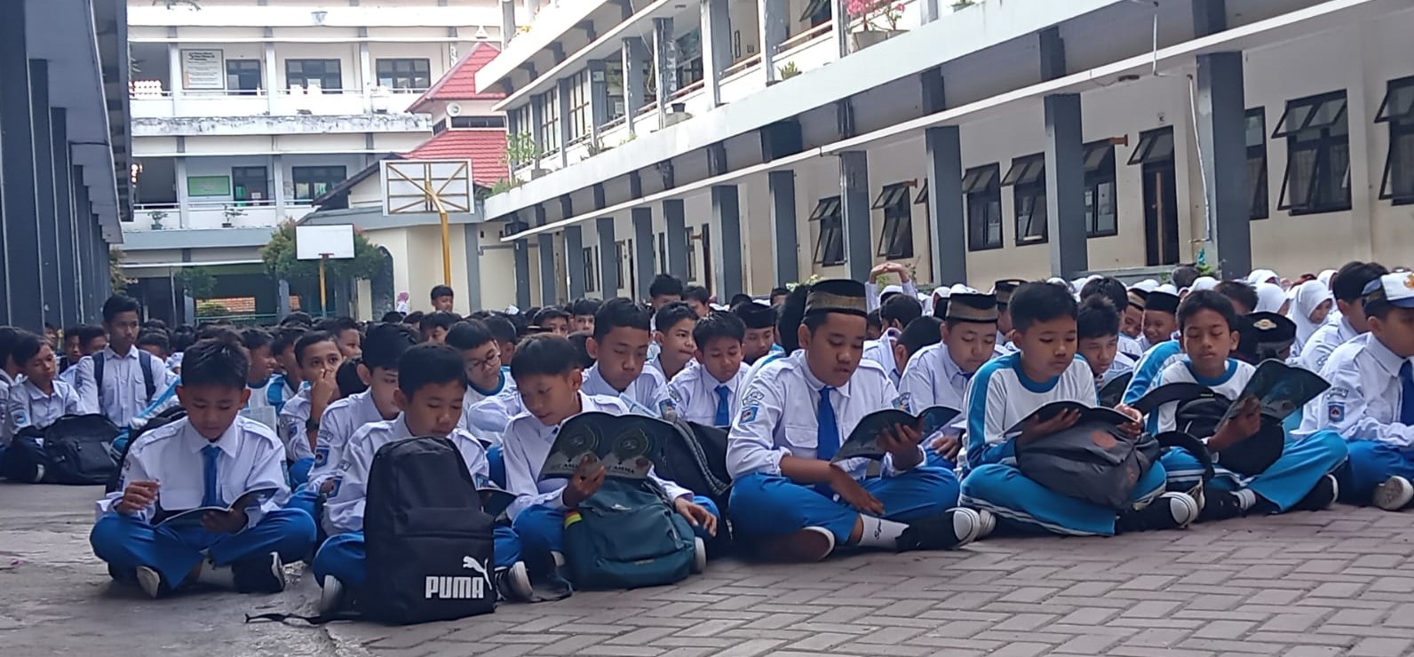 Siswa SMPN 6 Mataram membaca Alquran pada peringatan HAN 2025 di lapangan sekolah setempat, Rabu lalu (23/7).