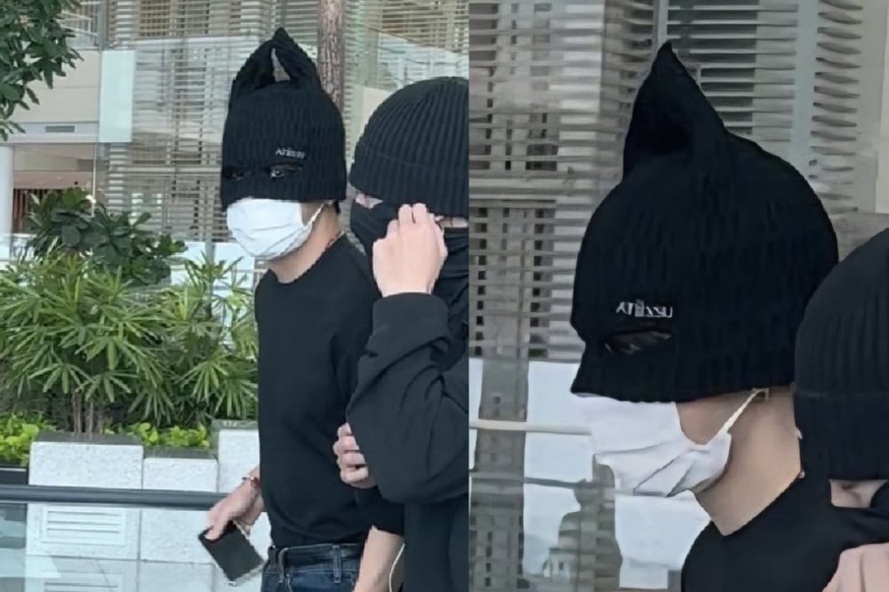 Beanie unik V BTS saat di bandara.