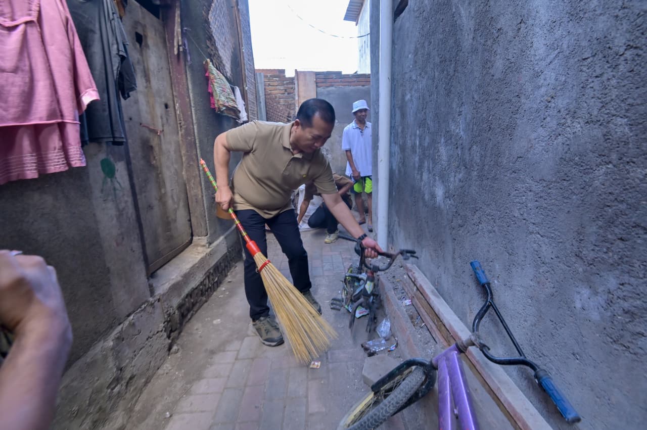 Gubernur NTB Lalu Muhamad Iqbal sedang menyapu salah satu ruang jalan lingkungan. Baksos HUT RI, Gubernur Iqbal Ajak Masyarakat Jaga Kebersihan Sungai