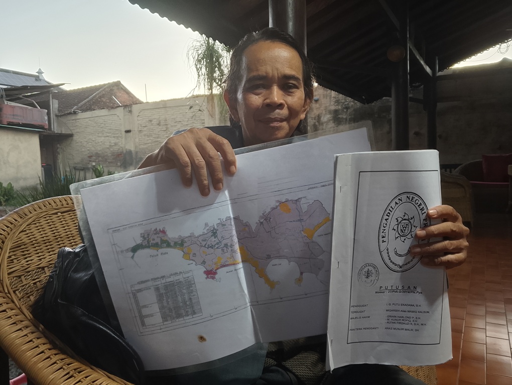 TUNJUKKAN BUKTI: Tim Penasihat Hukum Lalu Arif Widia Hakim menunjukkan bukti putusan dan peta blok lahan bukit Seger yang telah dimenangkan, Minggu (12/10).&nbsp;
