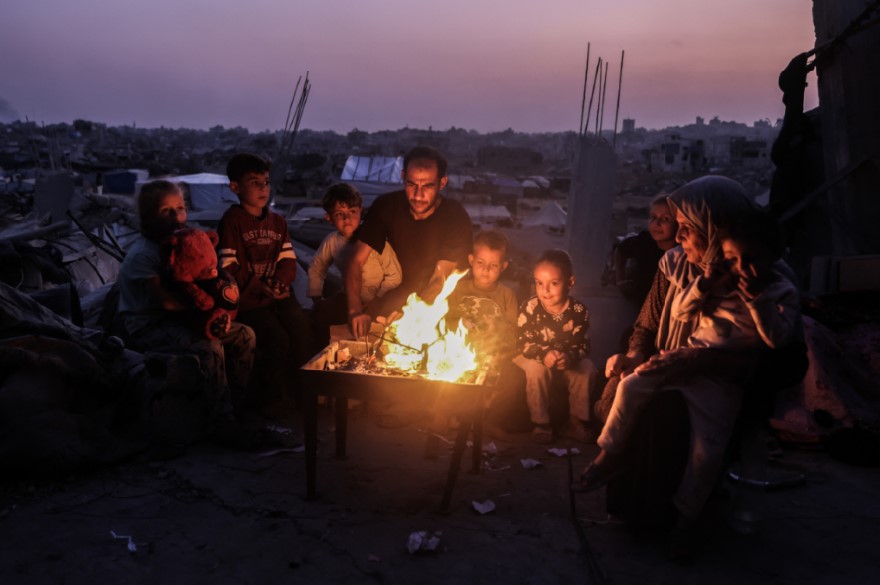 MENYALA: Salah satu keluarga di Jabalia, Gaza, berkumpul dekat api anggun di reruntuhan rumah. Keberadaan mereka terancam oleh warga Israel yang mulai memasuki tanah Palestina.