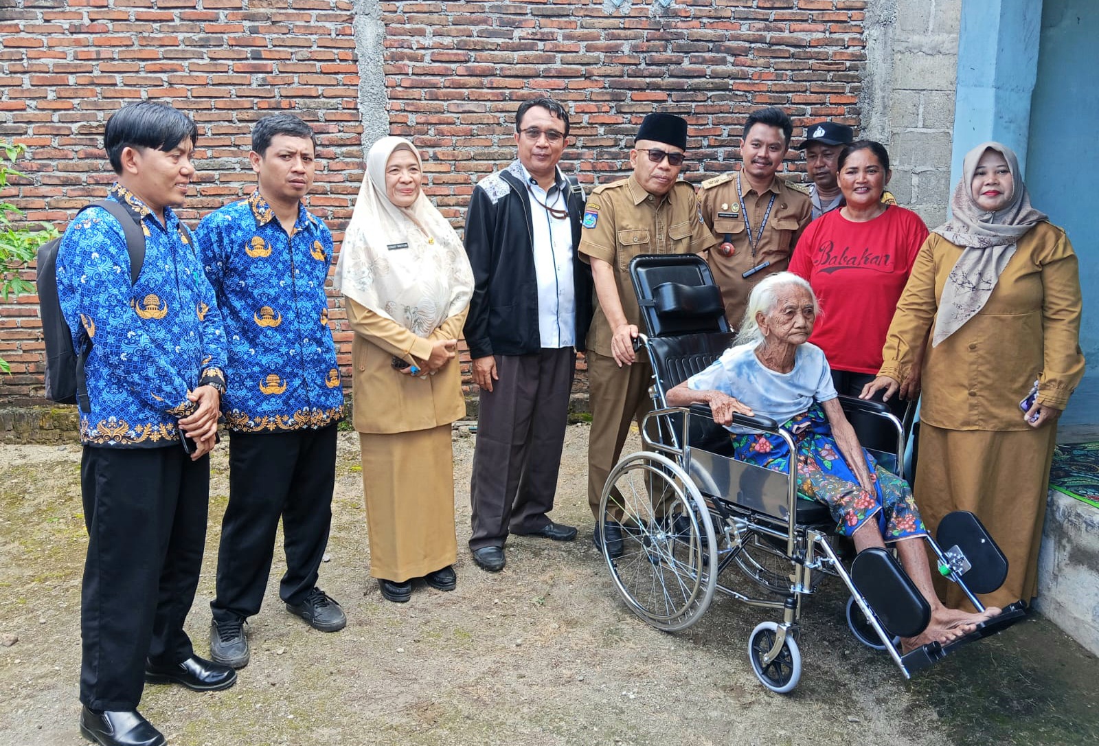 PEDULI: Kepala Dinas Sosial Lobar Lalu Winengan saat menyerahkan bantuan kursi roda kepada Lansia di Lingkungan Babakan Gerung Lobar.