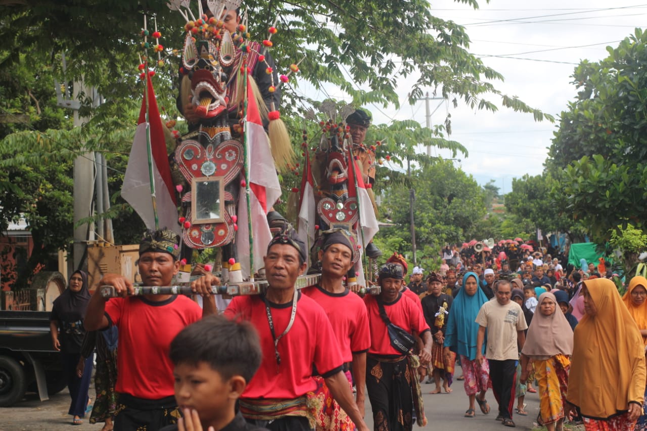 MERAWAT WARISAN: Kadis Pariwisata Lombok Timur dan Kades Tebaban saat dipikul menggunakan Praja Petak Jangger milik masyarakat Desa Tebaban saat mengelilingi desa Tebaban dengan diiringi Gamelan Tengk