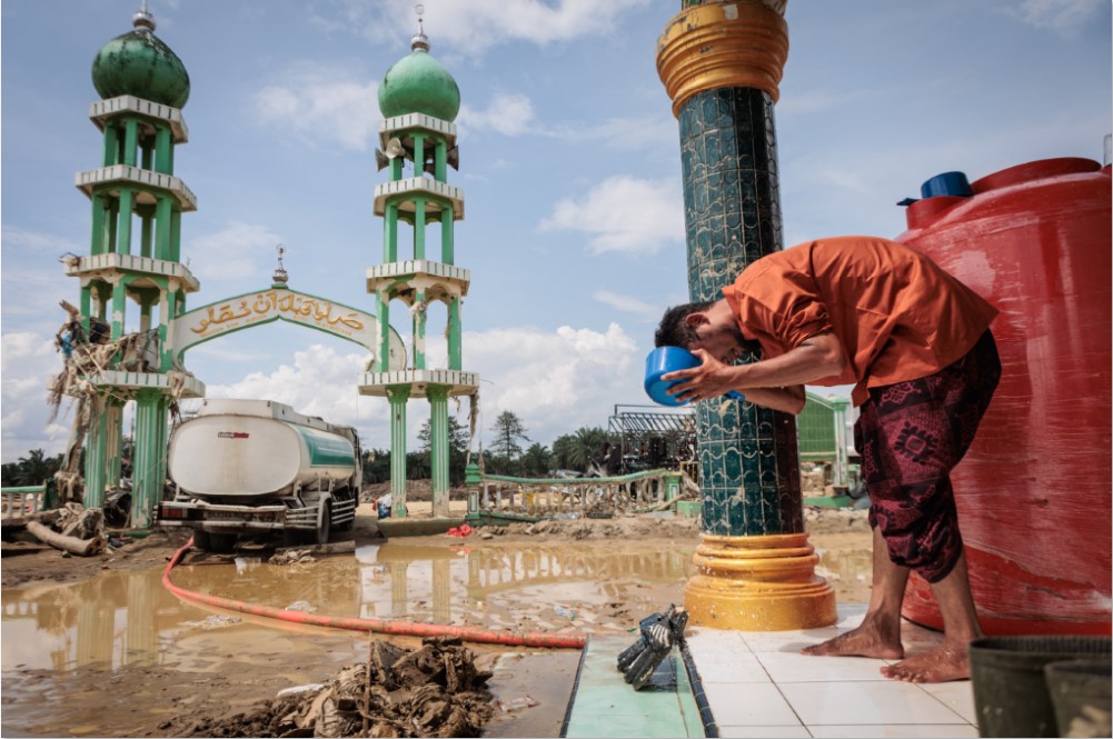 BENCANA BUKAN KENDALA: Seorang pria muslim sedang berwudu sebelum salat Jumat di Masjid Al Ihsan yang sebagian rusak akibat banjir di Aceh Tamiang, Provinsi Aceh, Jumat (12/12).
