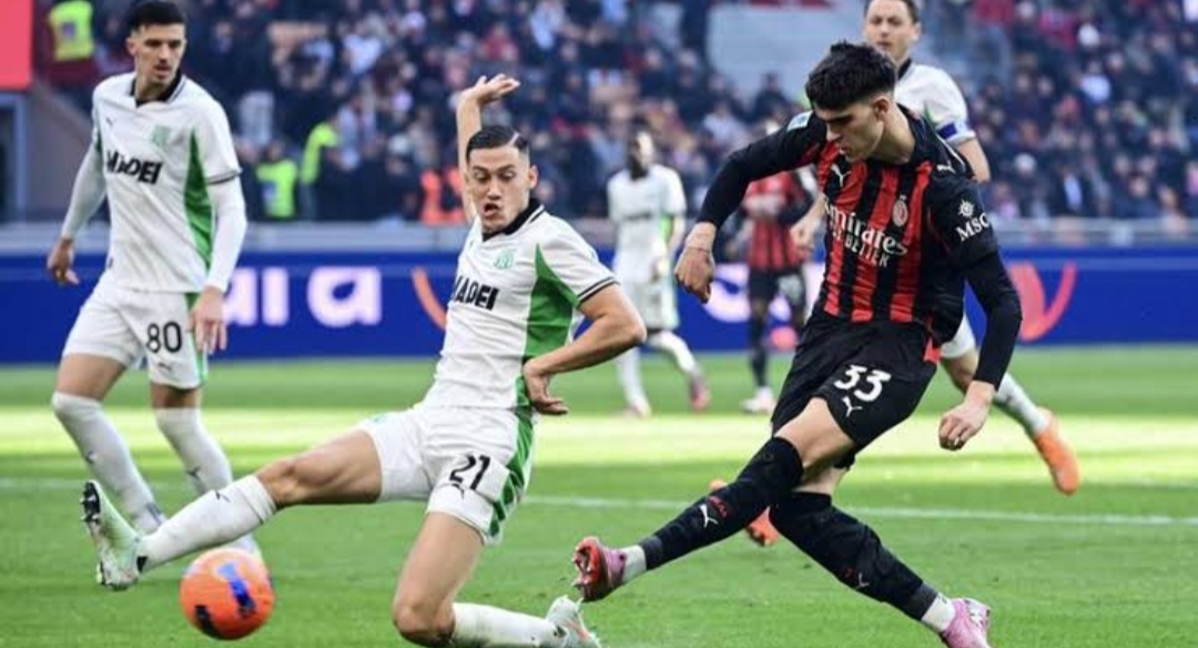 Jay Idzes tampak menghalau bola sepakan pemain AC Milan