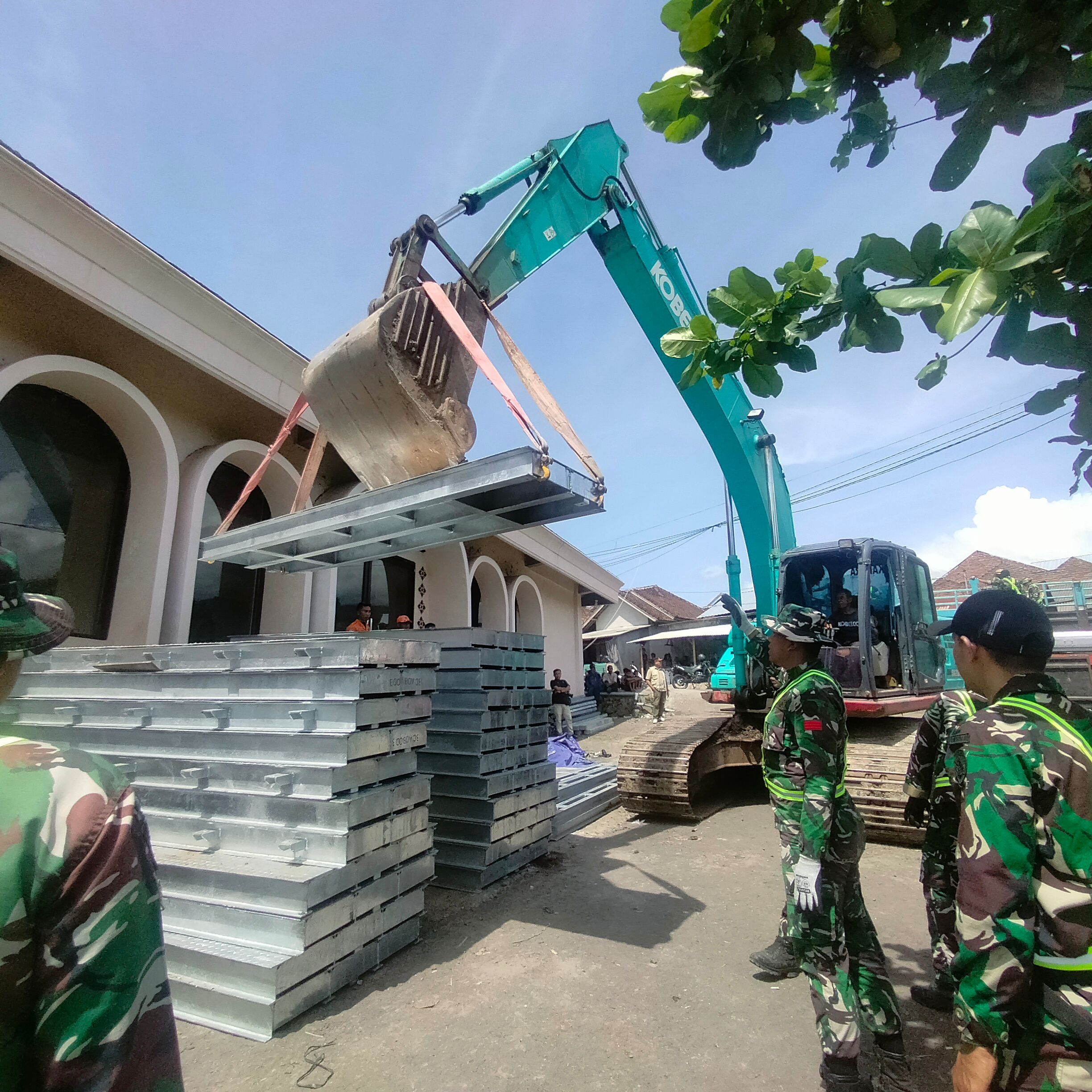 Personel TNI saat menurunkan material jembatan Bailey yang akan dipasang di jembatan Dusun Aik Beta, Desa Perigi Kecamatan Suela yang terputus akibat hujan lebat pada November 2025 lalu.