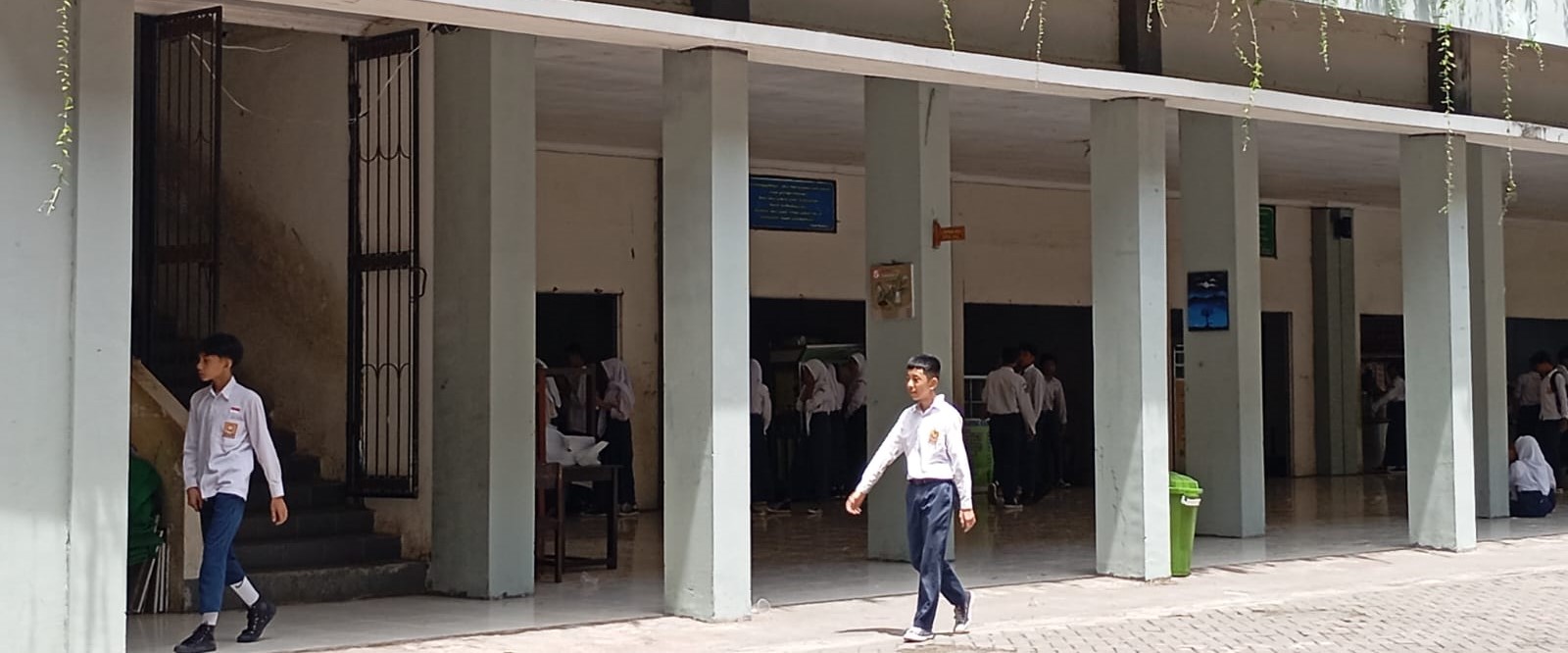 Dua siswa SMPN 6 Mataram berjalan di halaman sekolah pada jam istirahat, belum lama. Kekosongan Kasek definitif ancam persiapan TKA, akademi pertanyakan penundaan pelantikan kasek.