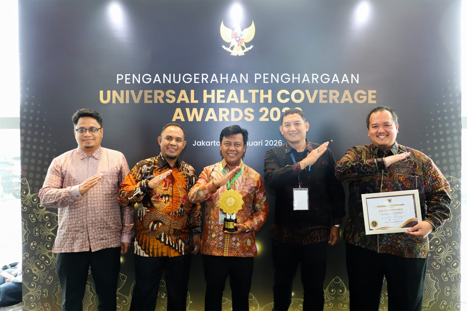 Bupati KSB Amar Nurmansyah (tengah) saat menerima piagam penghargaan UHC Award didampingi pejabat dinas kesehatan KSB, Selasa (27/1).