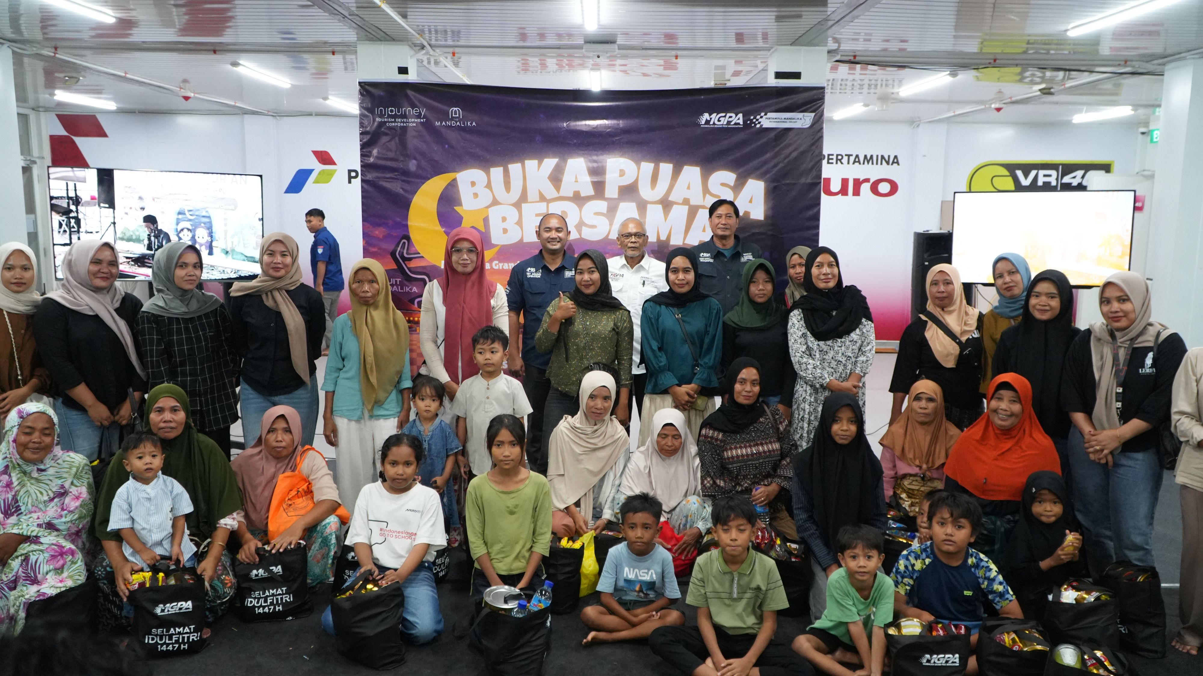 Direktur Utama PT MGPA Priandhi Satria berfoto bersama para warga usai menghadiri kegiatan berbuka puasa bersama di Dinning Hall, Sirkuit Internasional Mandalika, Lombok Tengah, Jumat (13/3)