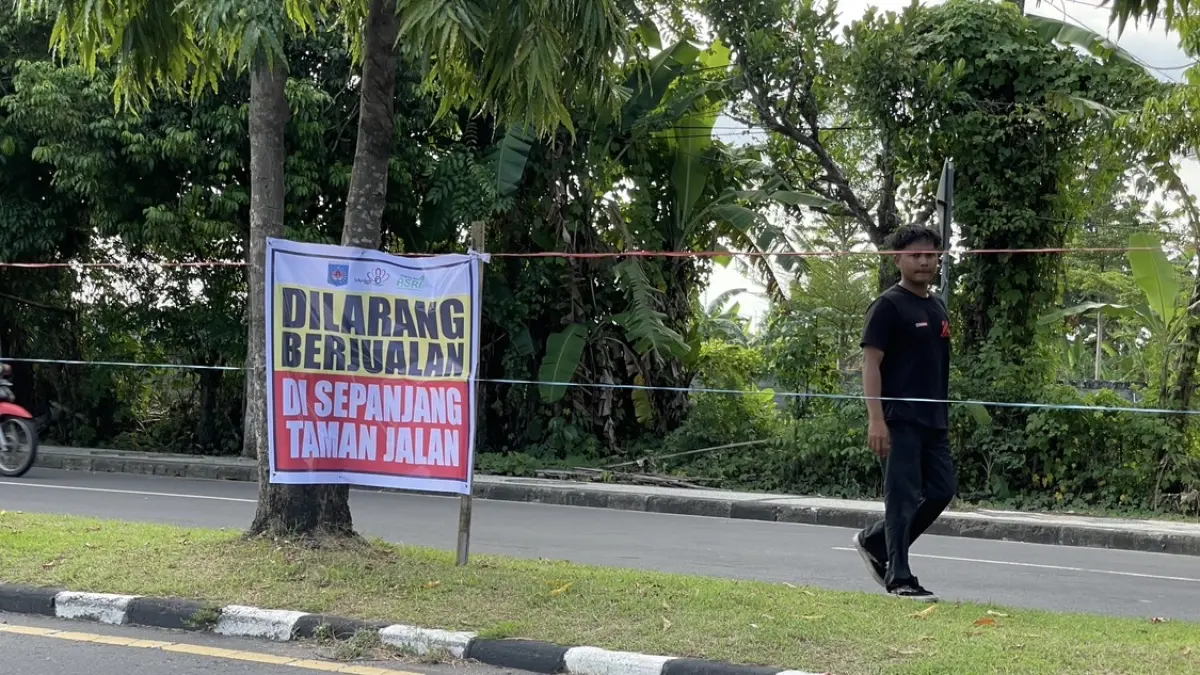 ATURAN BARU: Tali rafia dipasang di sepanjang median jalan depan Asrama Haji sekaligus imbauan larangan bagi PKL berjualan selama musim keberangkatan haji di Kota Mataram, Jumat (17/4). 