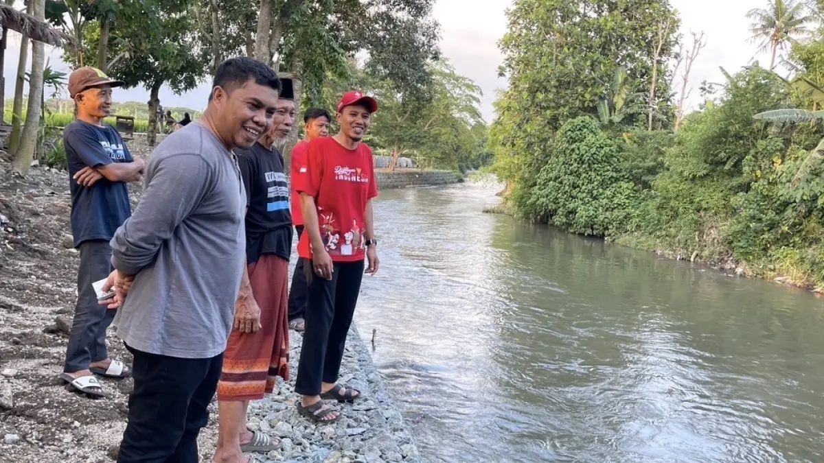 Abd Rachman (baju abu) saat mengecek hasil pengerjaan thalud di sungai kawasan Marong Karang Tatah.  