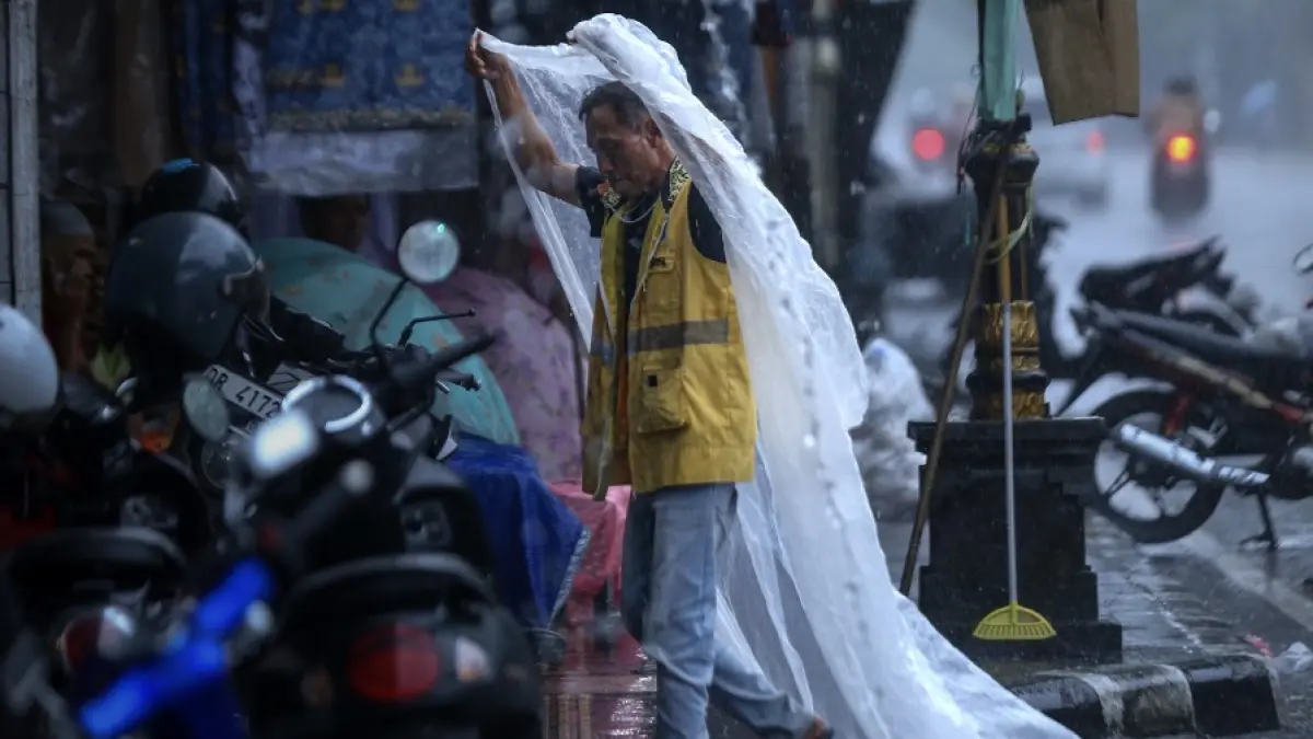 PERATURAN DAERAH: Seorang jukir di tengah hujan, beberapa waktu lalu. 