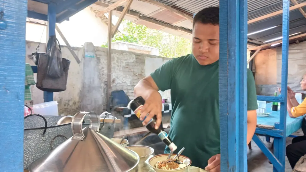 LAYANI PEMBELI: Insanul Kamil pemilik warung soto Sasak Amaq Sahdan saat menyiapkan soto kepada sejumlah pembeli.
