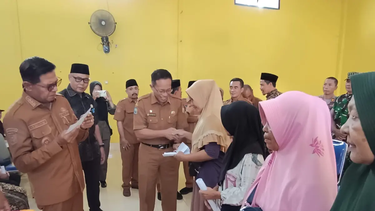 BANTUAN STIMULAN: Bupati Lombok Timur Haerul Warisin menyerahkan bantuan stimulan kepada para pedagang korban kebakaran di Pasar Pringgabaya