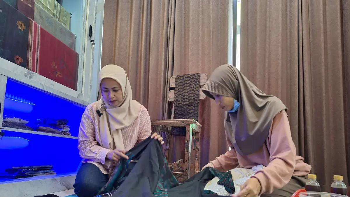 KENALKAN PRODUK: Pemilik Nyalakok Tenun Indah Rahmawati (kiri) memperkenalkan salah satu motif tenun kepada calon pembeli, beberapa waktu lalu. (Istimewa)
