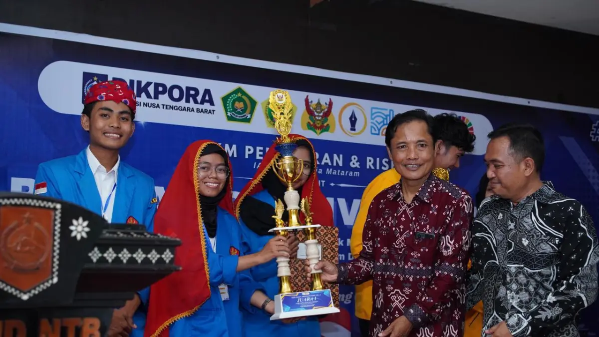 Kepala Dikpora NTB Syamsul Hadi menyerahkan piala pada salah satu juara. (IST/LOMBOK POST)